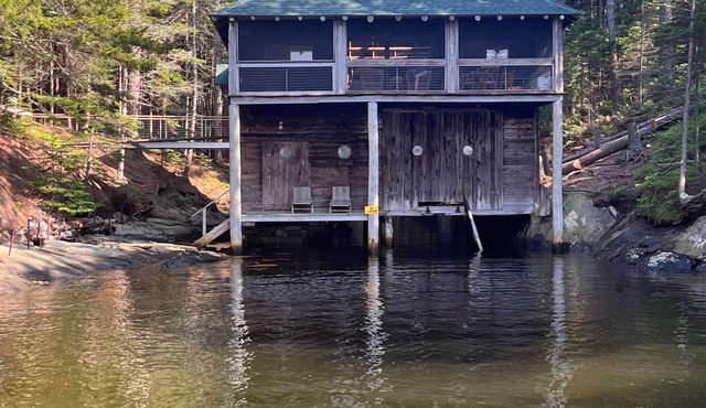 Renovated 3-BR boathouse built atop water in quiet cove; private float & trails